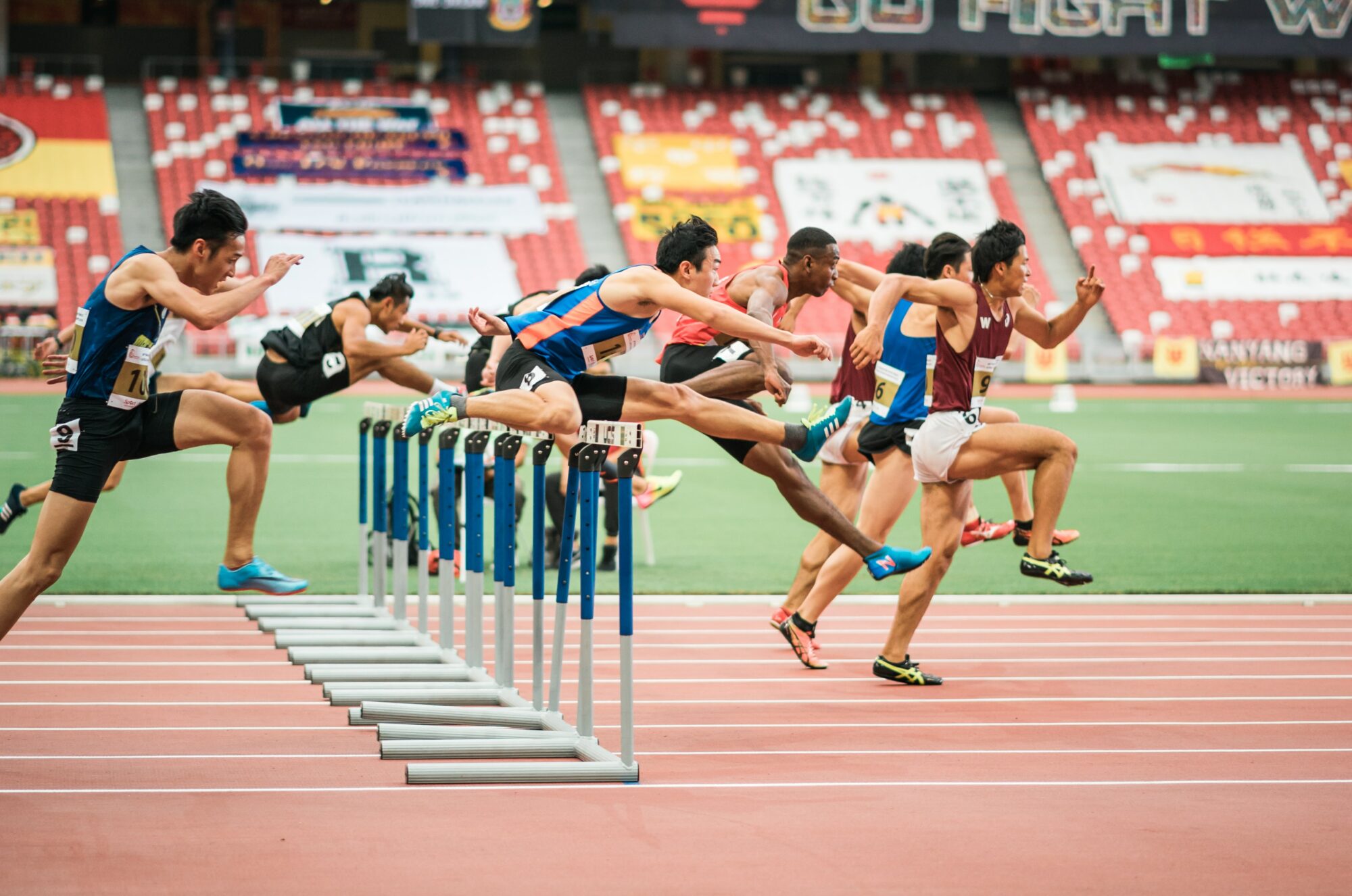 people jumping over stands in race