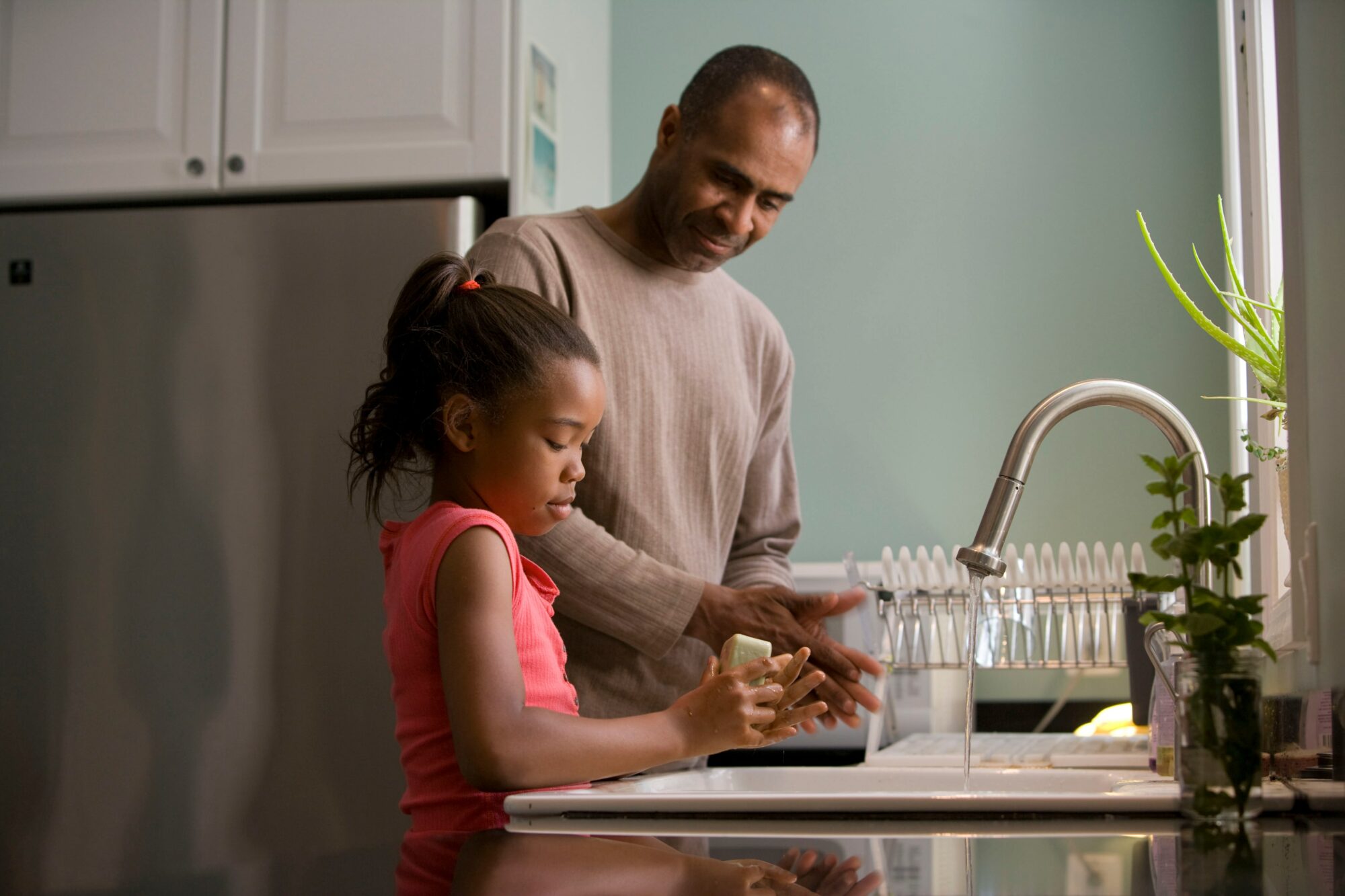 dad and his daughter washing dishes