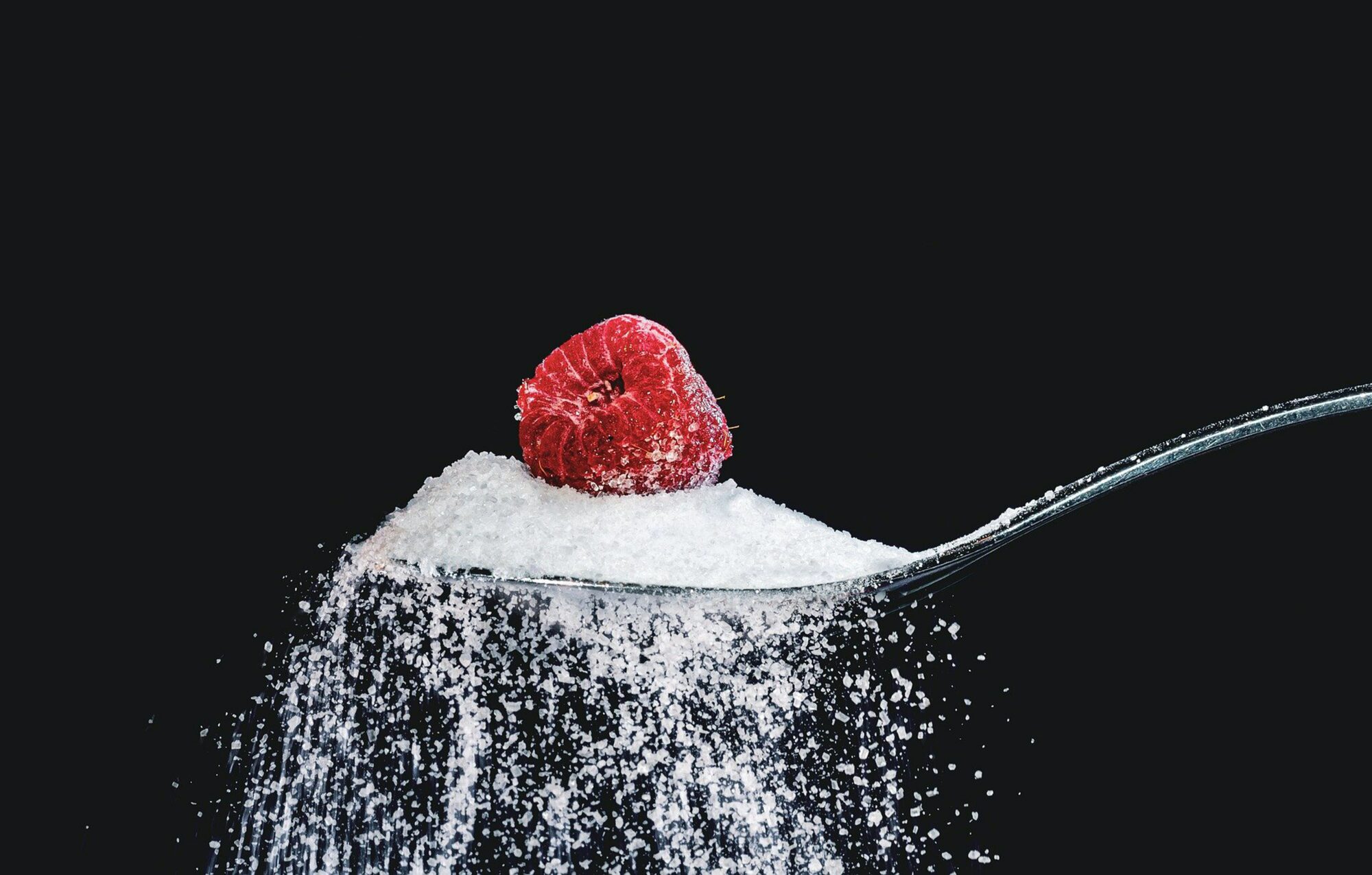 sugar on spoon with raspberry