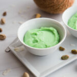 Close up - white bowl filled with green pistachio pudding.