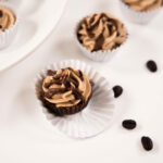 Close up - Two Mini Mocha Mousse Cups in paper liners, one partially unwrapped.