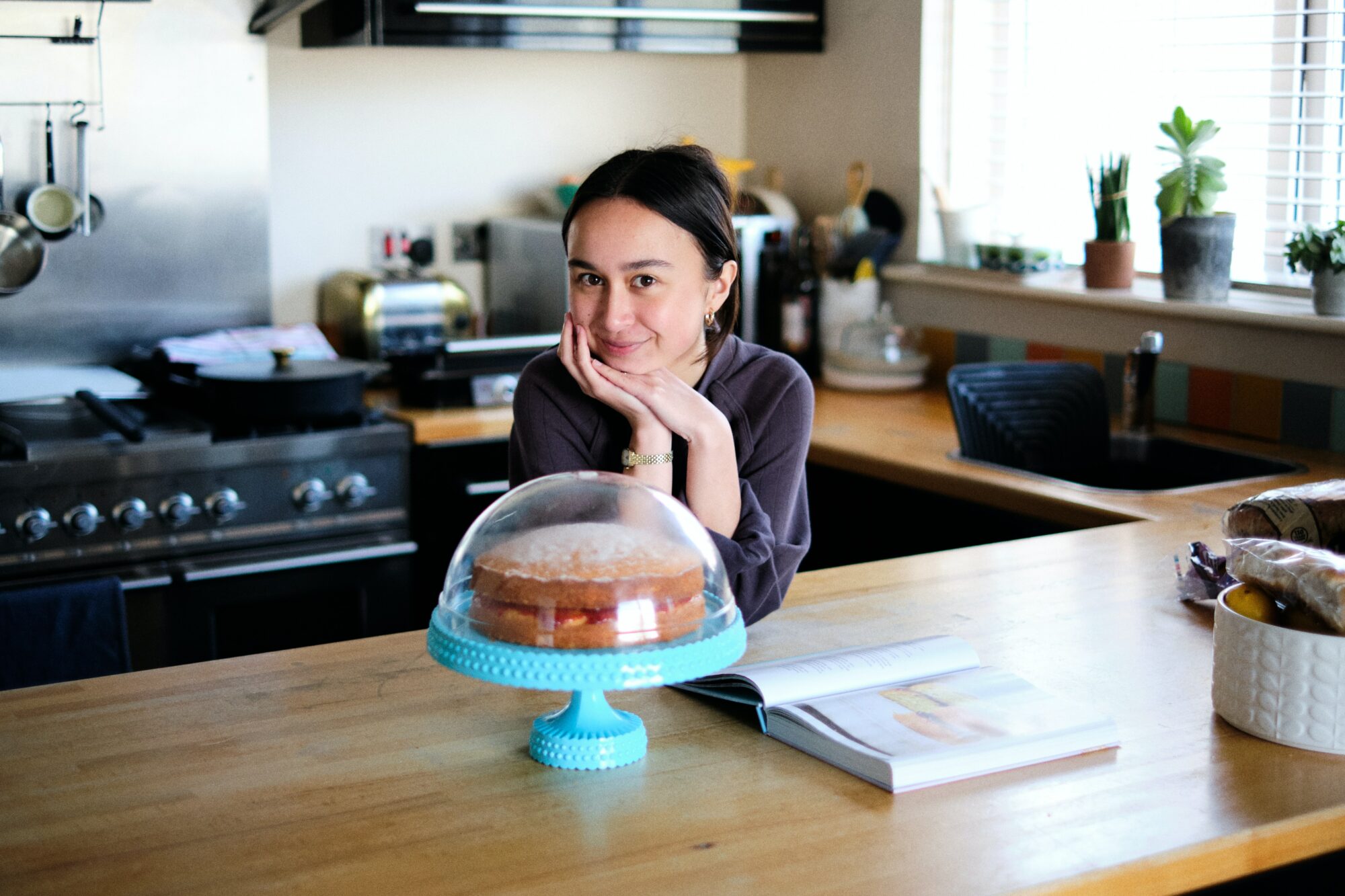 woman posing behind cake