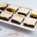 White tray filled with Cheesecake Brownies.