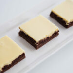 Close up - White tray filled with Cheesecake Brownies.
