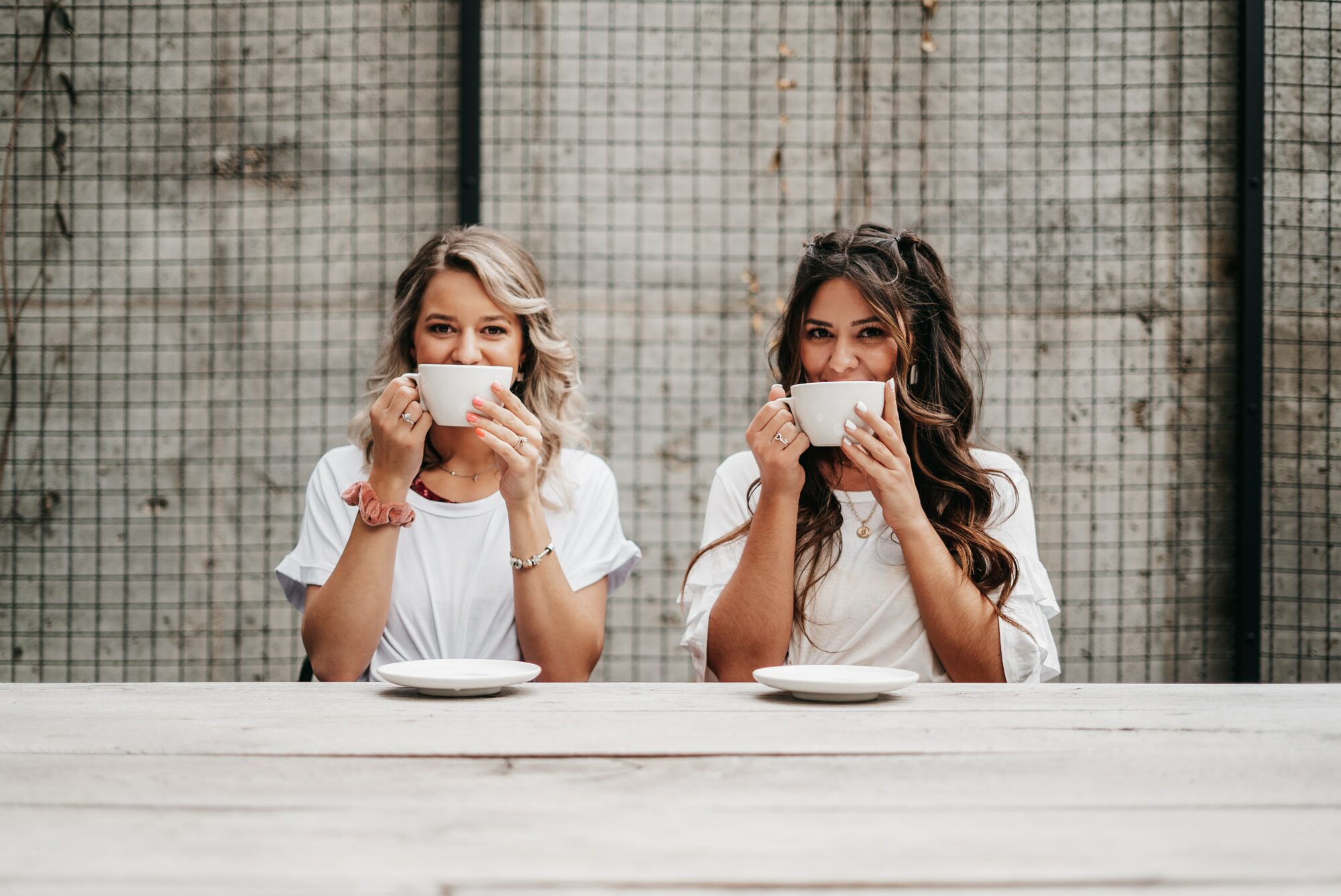 women holding up mugs