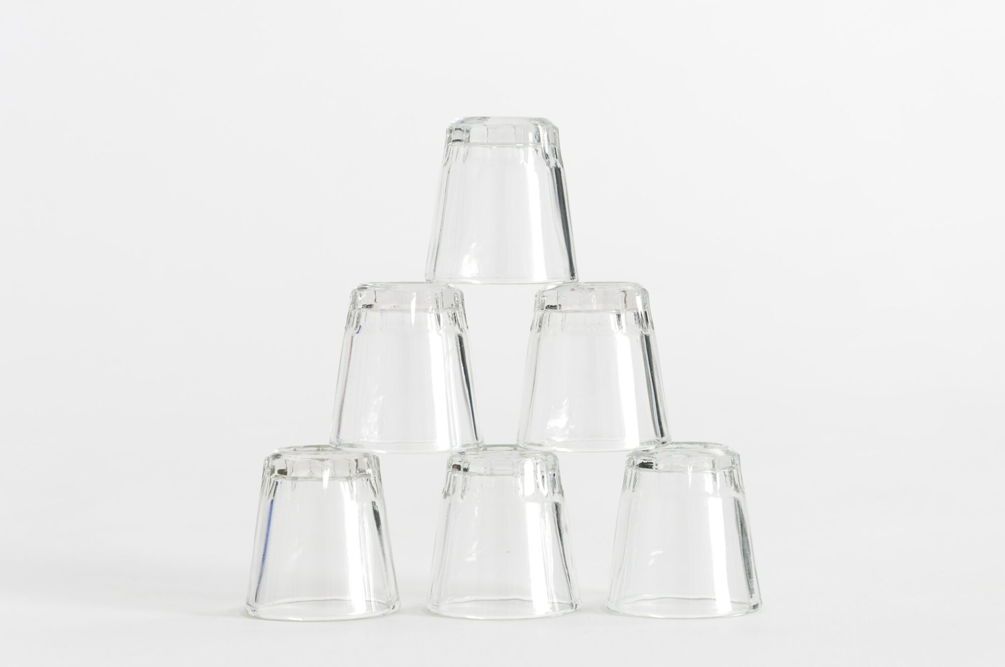 empty glasses stacked on top of each other