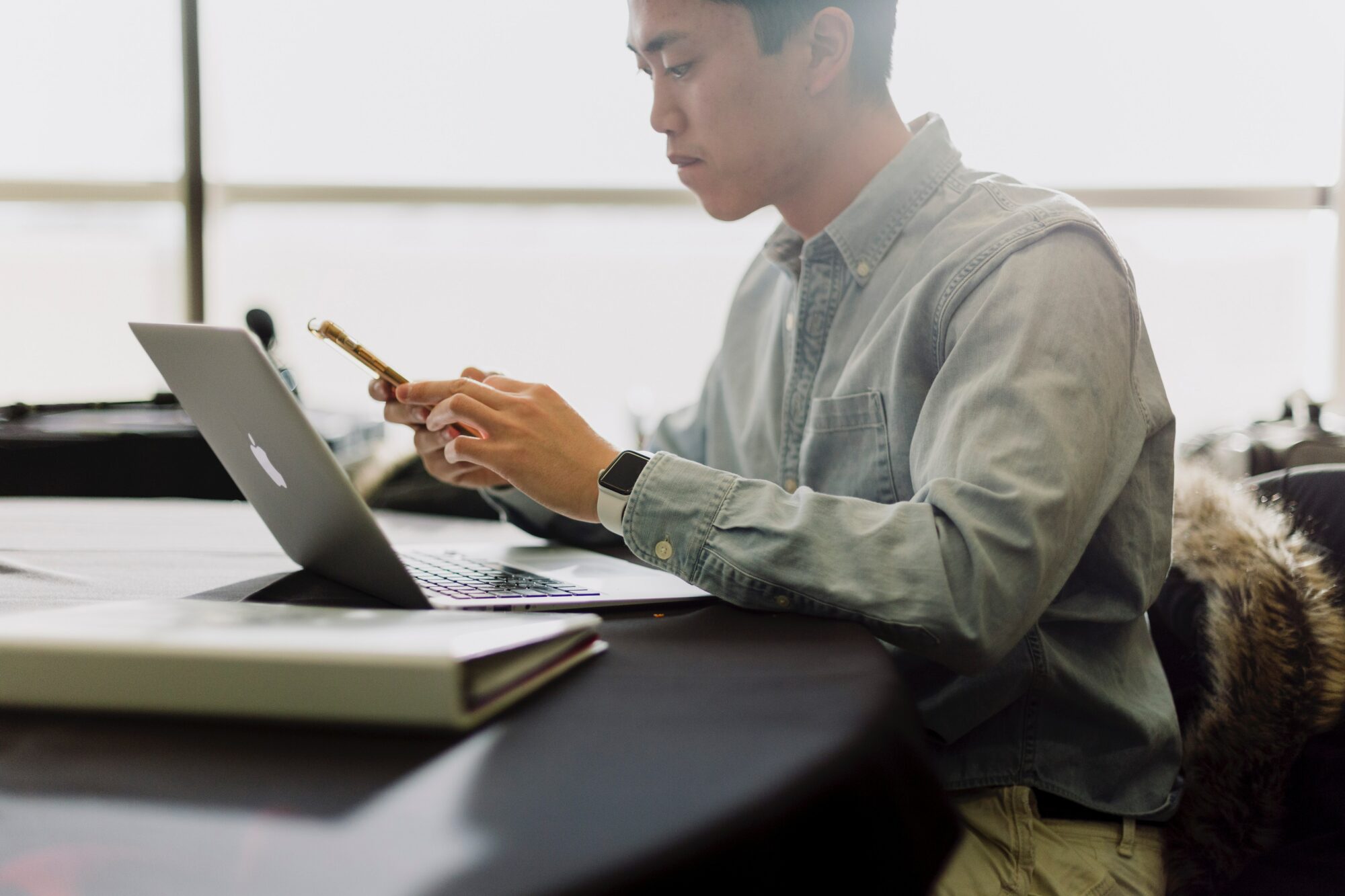 man doing two-factor authentication with phone and computer