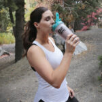 woman drinking Keto Chow while hiking
