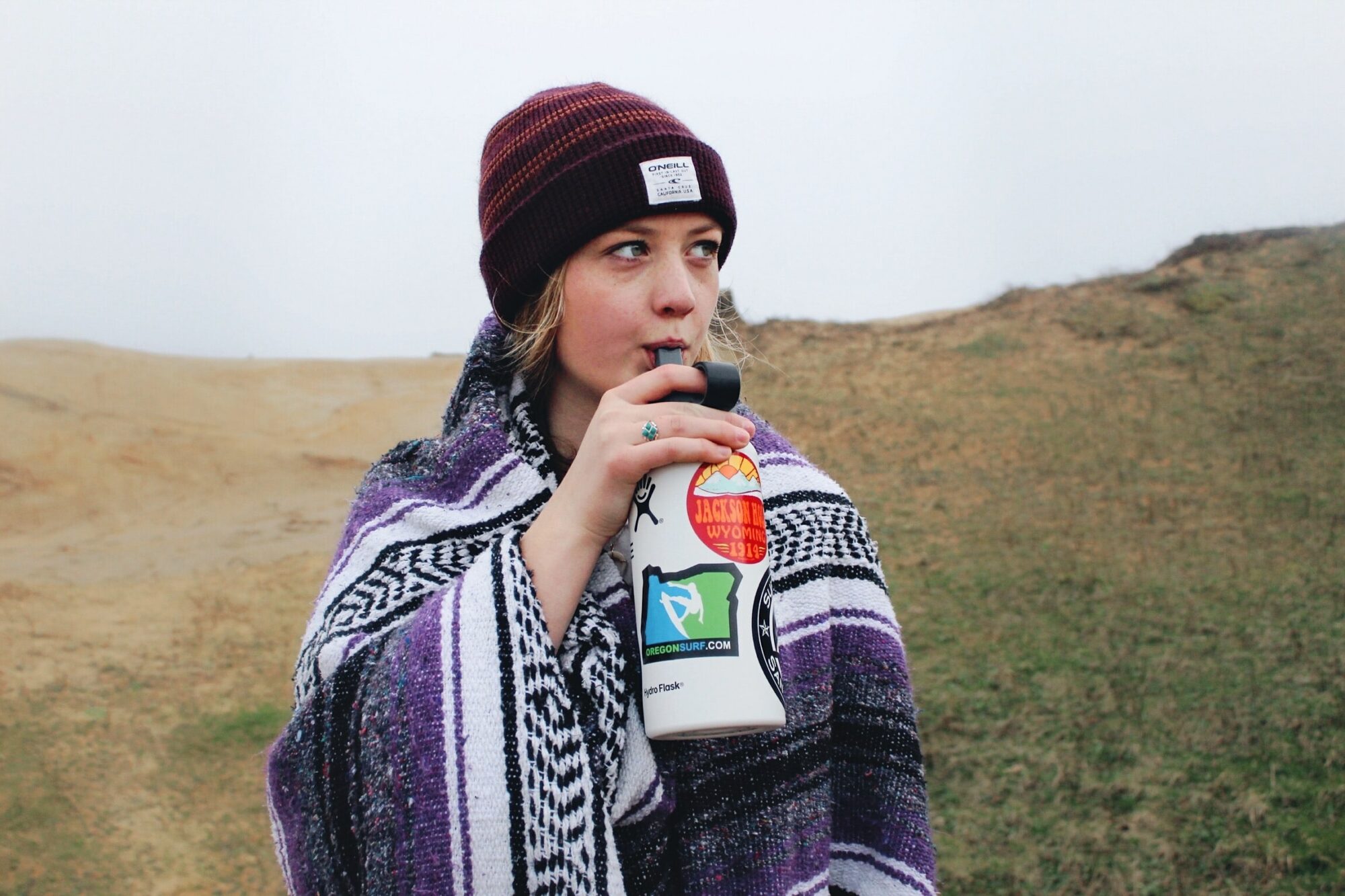 woman drinking from water bottle