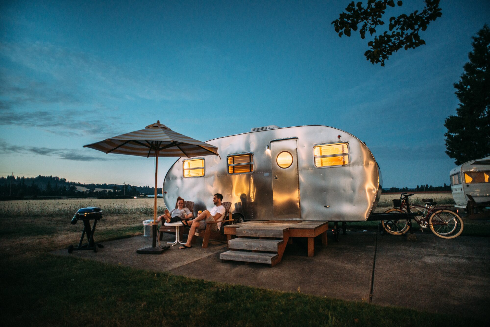 couple camping with camper