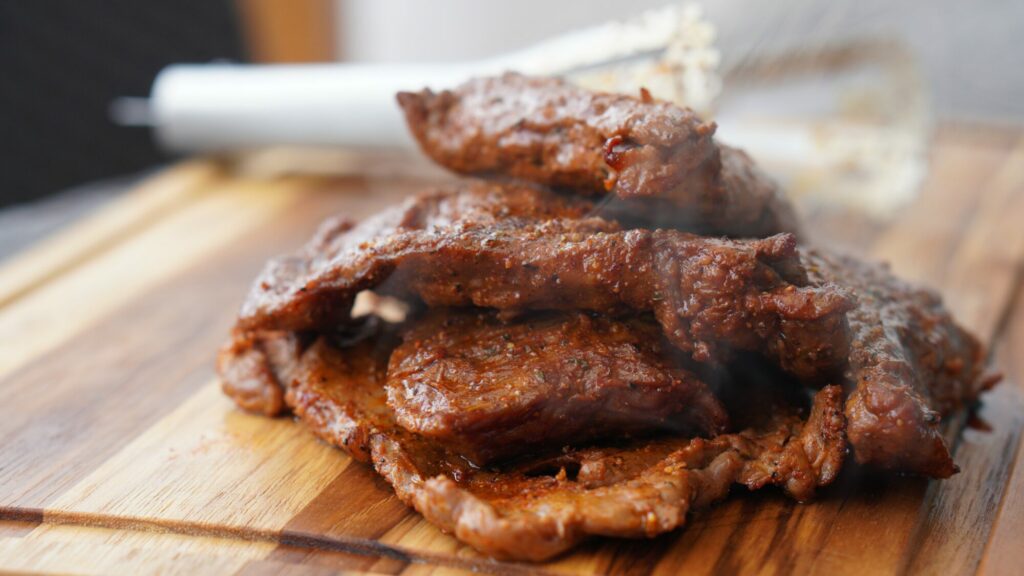 cooked meat on cutting board