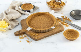 Cutting board with pie crust on it