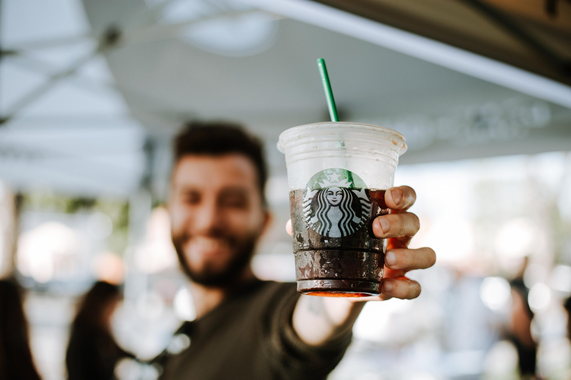 man holding a Starbucks drink