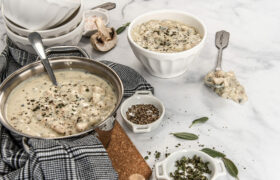 table with pot and bowl of soup