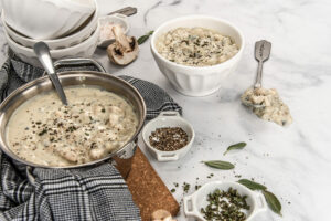 table with pot and bowl of soup