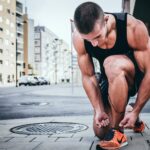 man tying shoes for workout