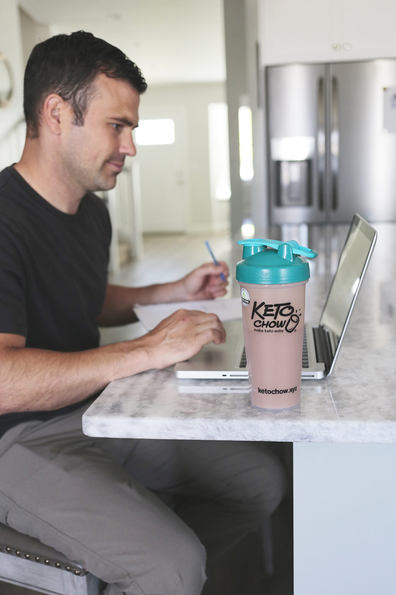 man on computer with keto chow