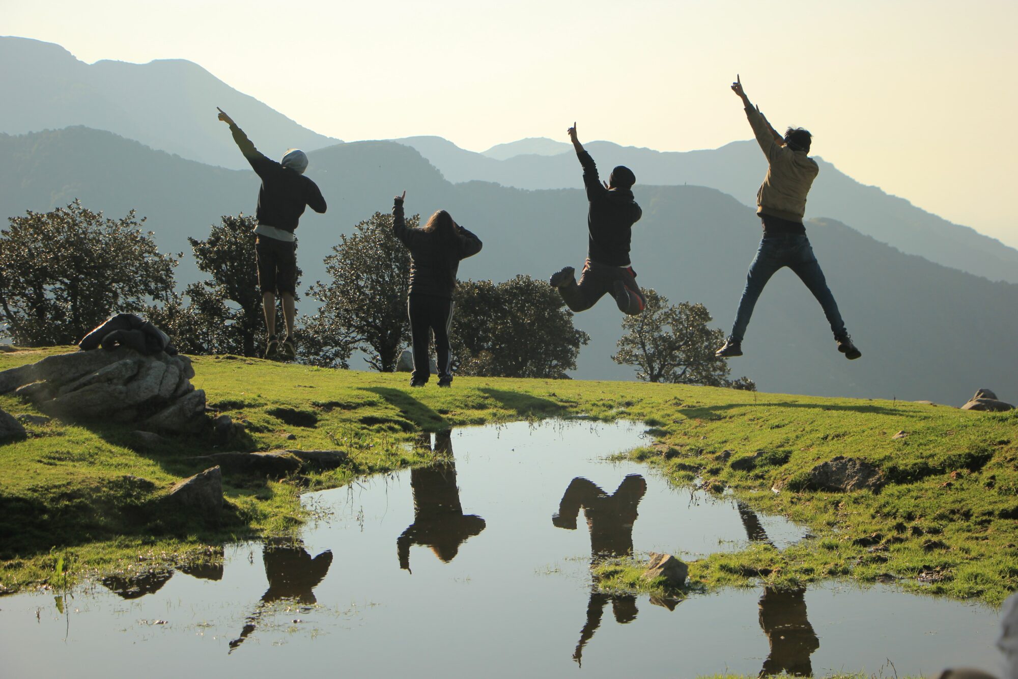 group jumping over puddle