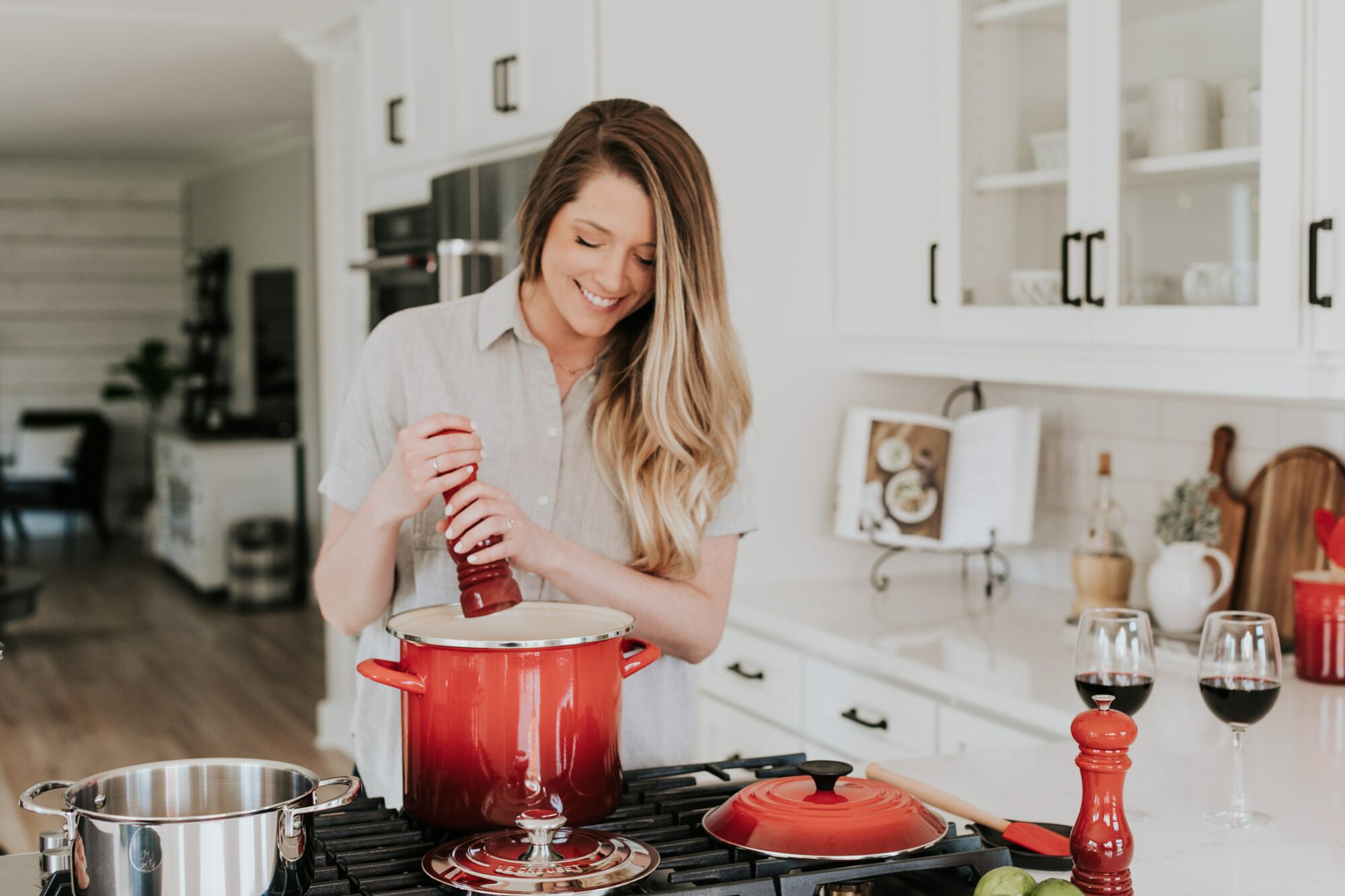 woman adding seasoning to dish