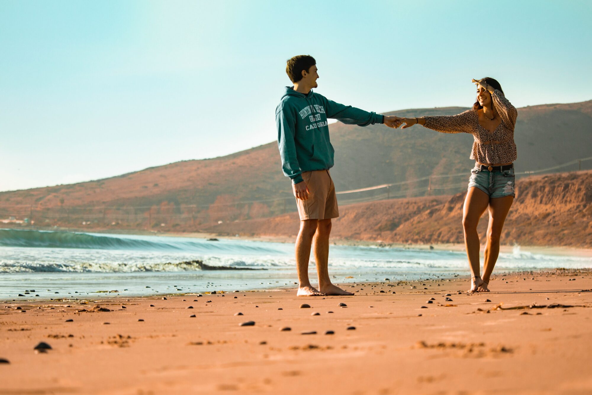 holding hands at beach