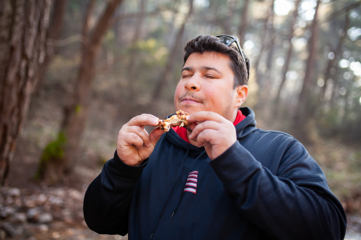 man eating chicken wing