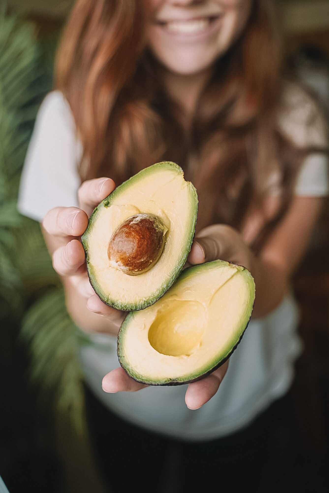 woman holding avocados