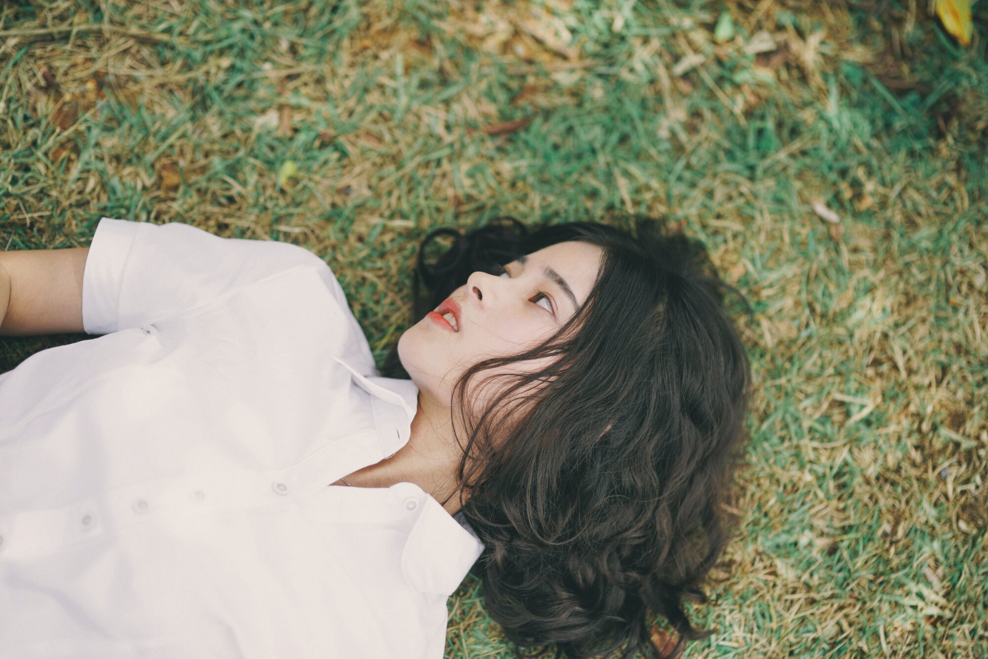 woman laying on grass