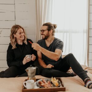 couple eating breakfast in bed