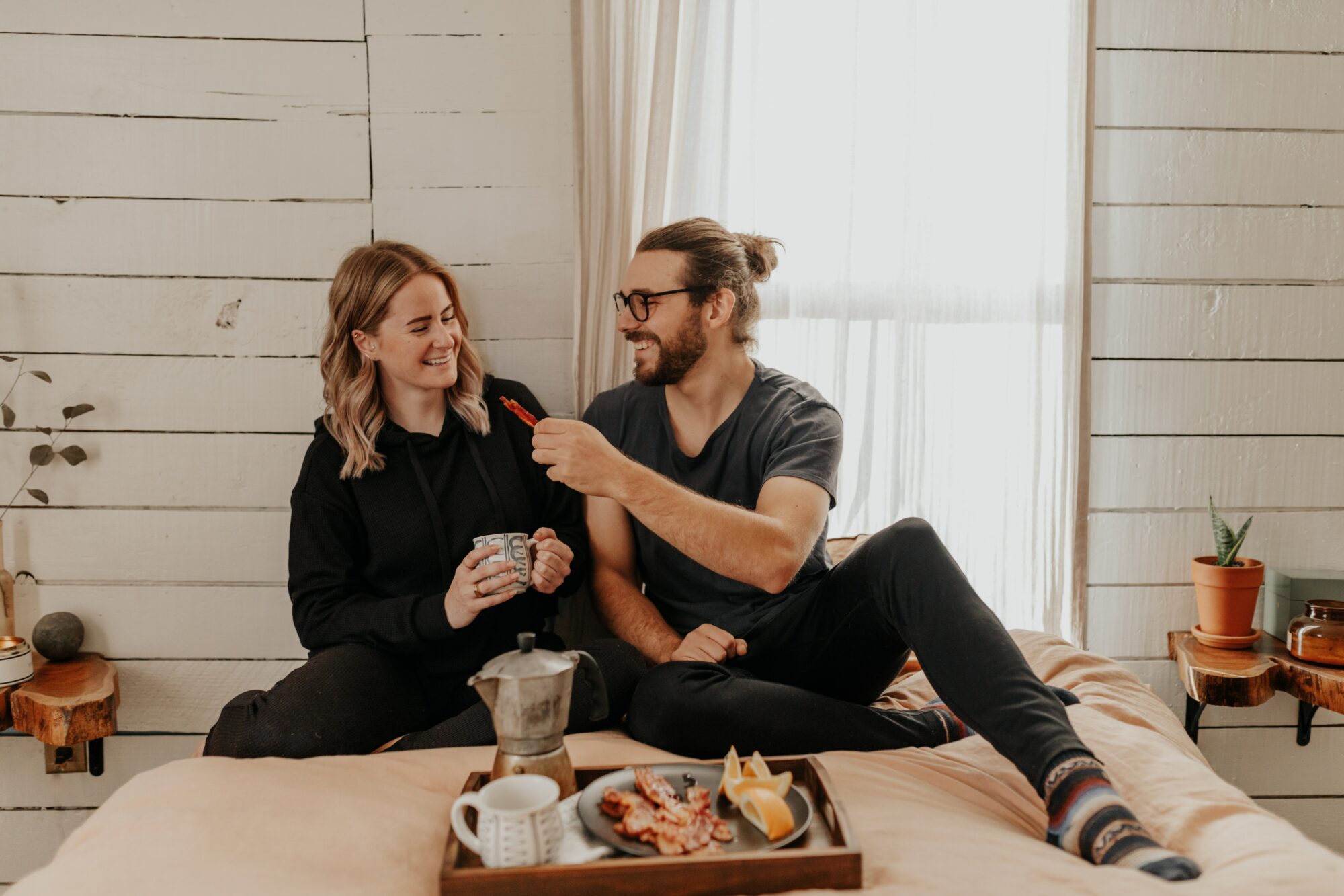couple eating breakfast in bed