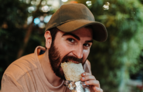 man eating burrito