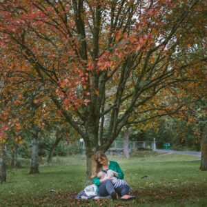 woman breastfeeding in park