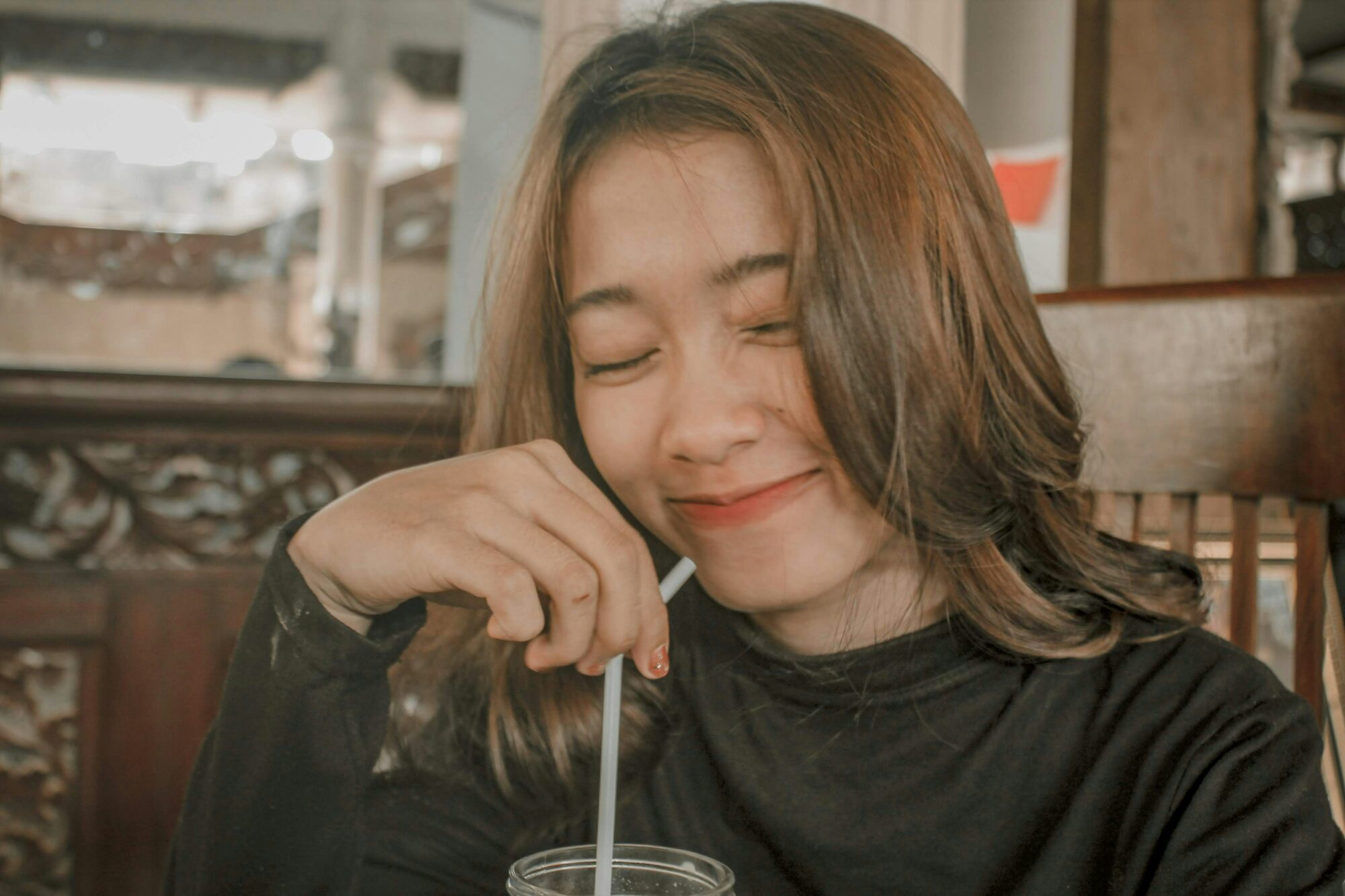 woman drinking out of straw