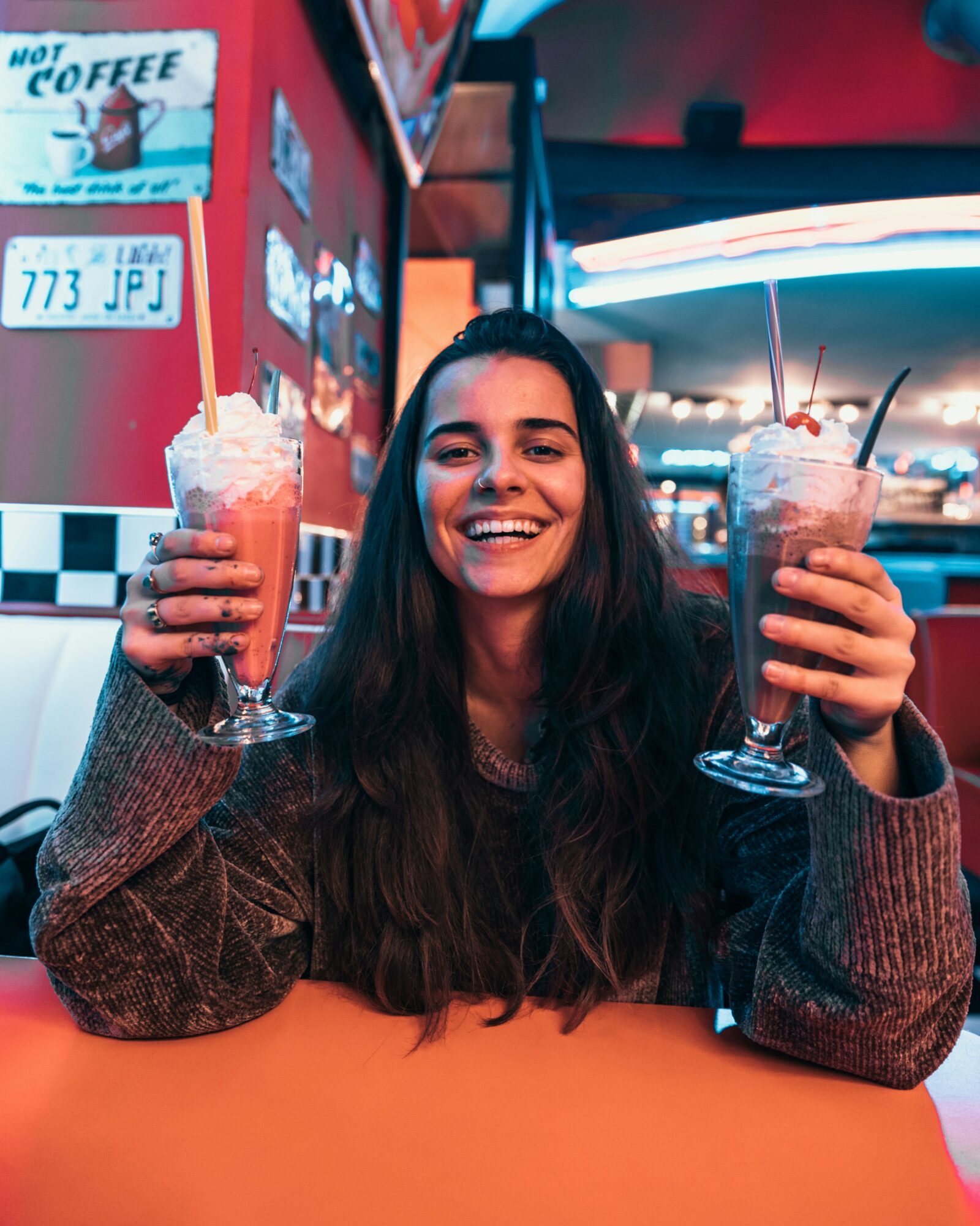 woman holding milkshakes