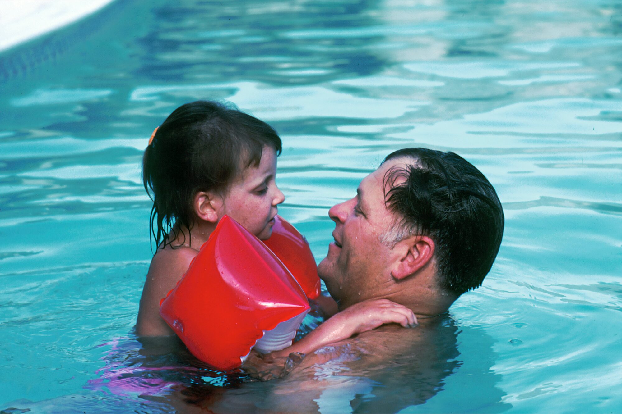 man swimming with his daughter