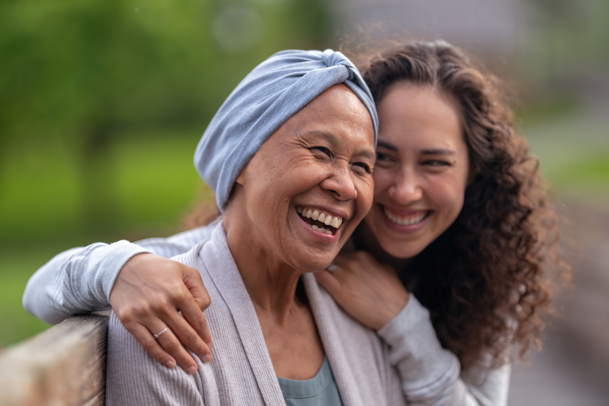 woman hugging another woman with cancer