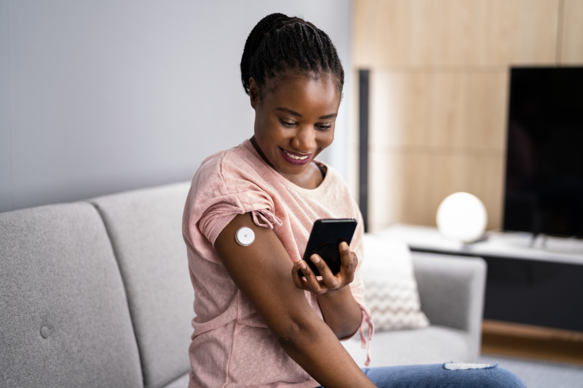 woman wearing cgm device