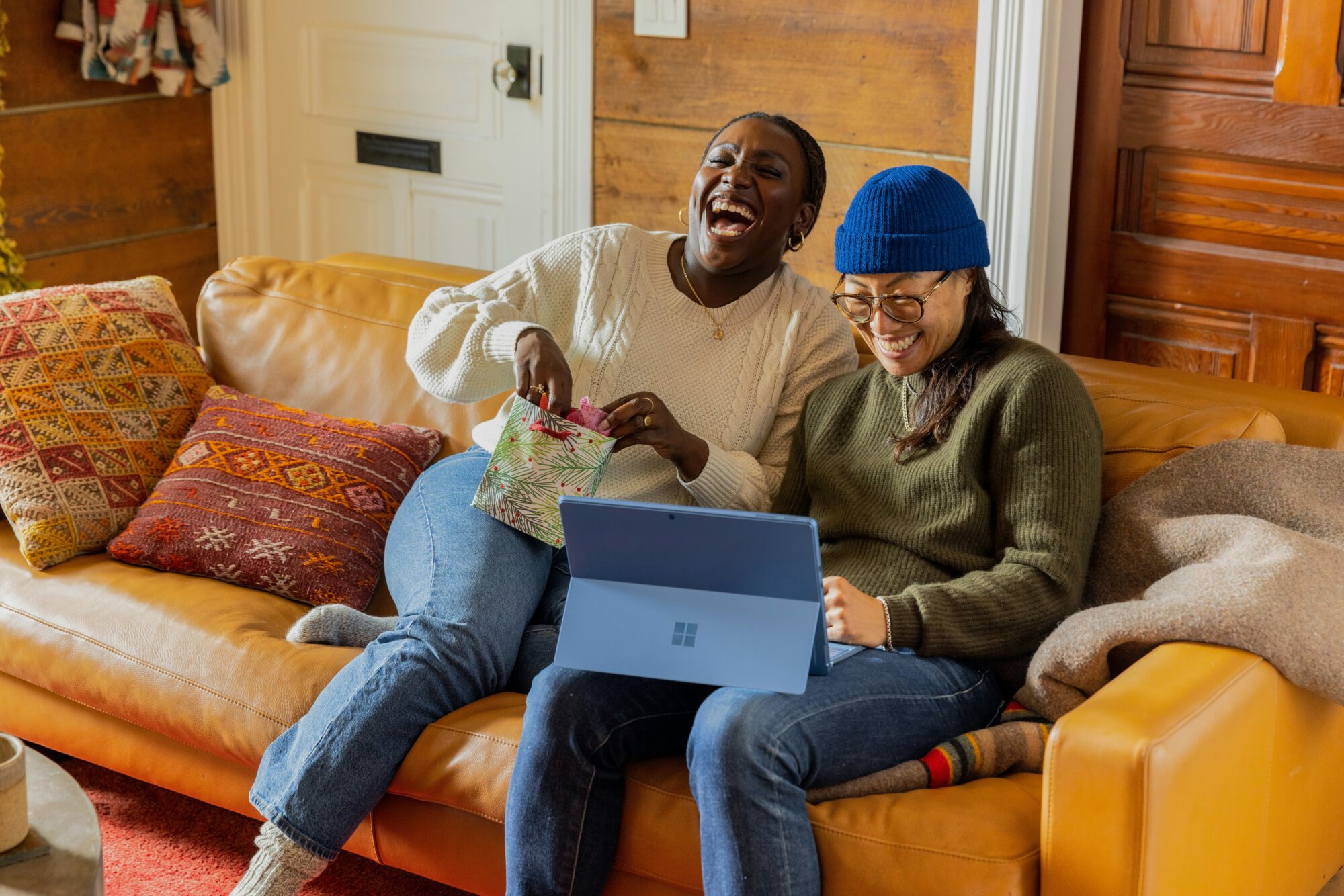 women laughing on couch