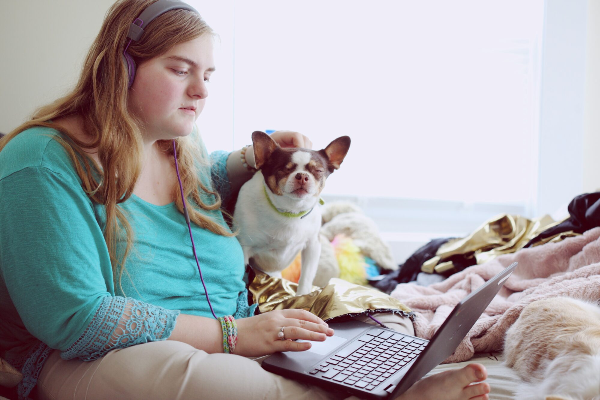 woman with her dog on bed