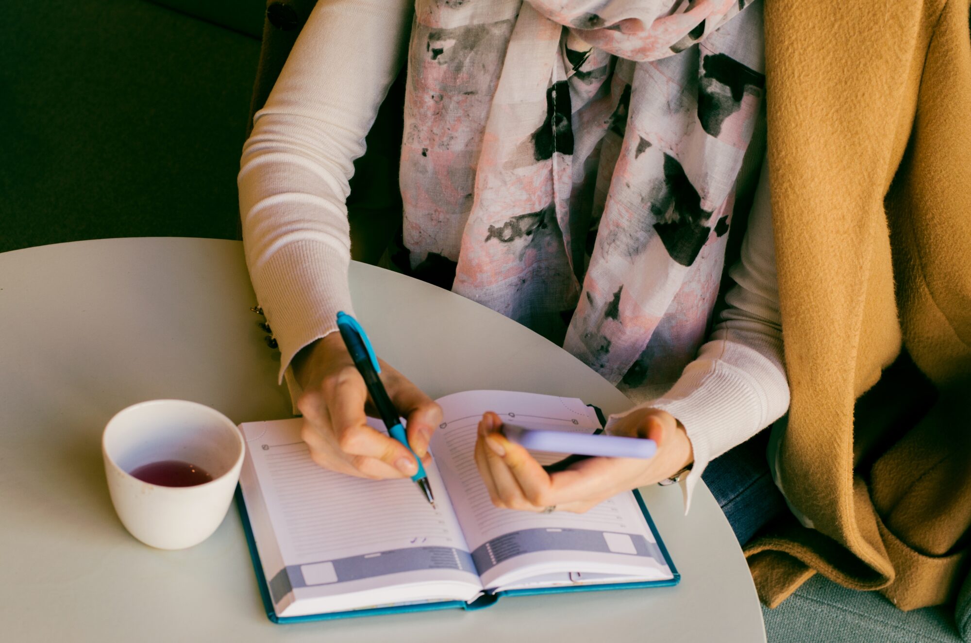 Woman using phone and planning her week