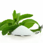 stevia plant with granulated stevia in foreground